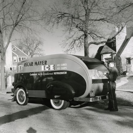 A man uses tongs to remove a block of ice from the back of an International D-300 owned by the Oscar Mayer Company as he makes a delivery to 150 Lakewood blvd, Maple Bluff. The home was owned by Jack Reynoldson, an Oscar Mayer employee.